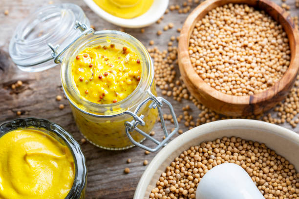 istock Different types of mustard and mustard seeds on a rustic wooden board 1419302909