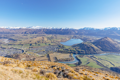The view over Queenstown and Lake Hayes from the Remarkables on a sunny spring day in New Zealand