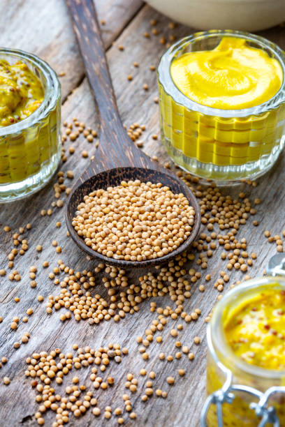 istock Different types of mustard and mustard seeds on a rustic wooden board 1419303145