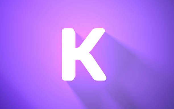 istock Neon Letter K on Purple Background (close-up) 1419303996