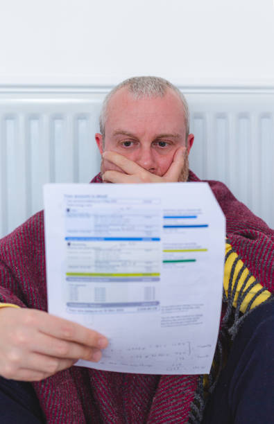 istock Worried man checking bills sitting next to radiator at home 1419308525