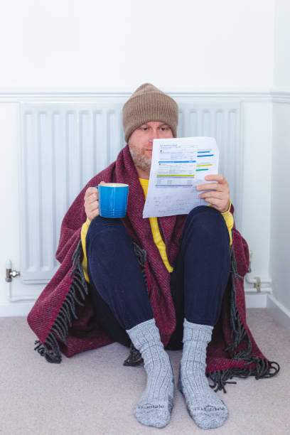 istock Worried man checking bills sitting next to radiator at home 1419308636