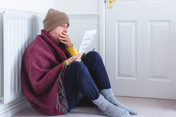 istock Worried man checking bills sitting next to radiator at home 1419308643