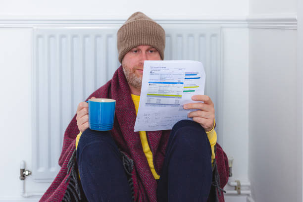 istock Worried man checking bills sitting next to radiator at home 1419308727