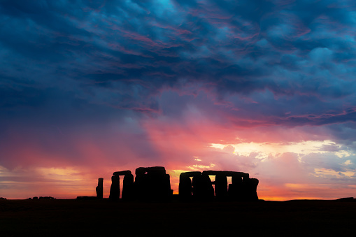 The famous prehistorical monument of Stonehenge with a dramatic sky at sunset, United Kingdom