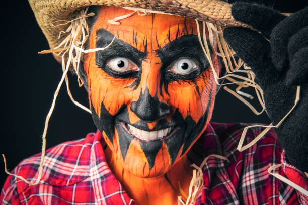 istock Creepy Smiling Pumpkin Scarecrow Smiling and Tipping Hat 1419312097