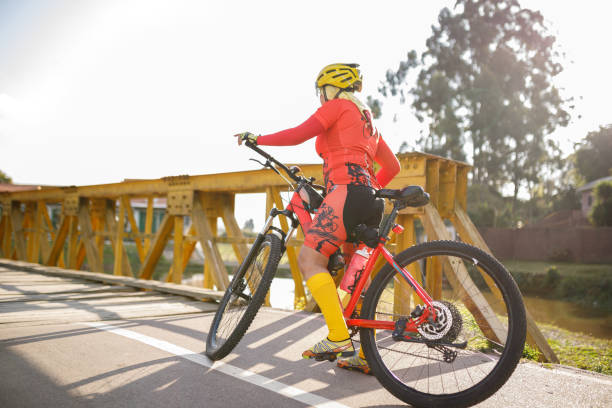istock Active woman on a bike before crossing a bridge 1419314074