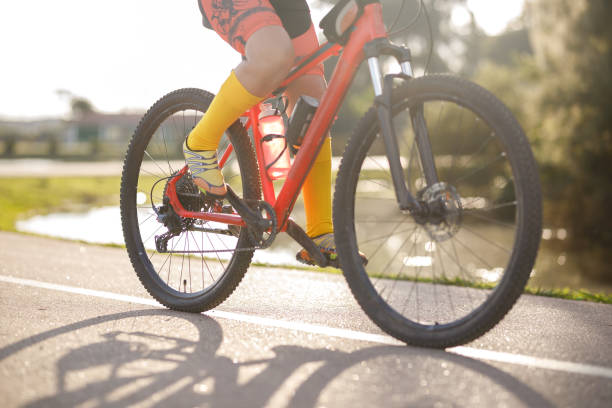 istock Active person in active wear riding a bike through a park 1419314140