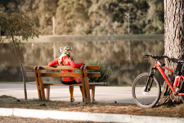 istock Woman in active wear resting on a bench after cycling 1419314171