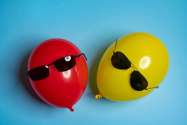 istock Red and yellow balloons with sunglasses 1419315058