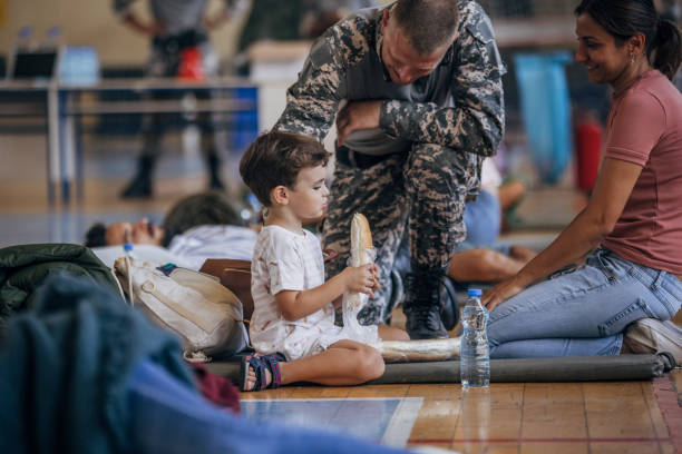 istock Soldier with civilians after natural disaster 1419315791