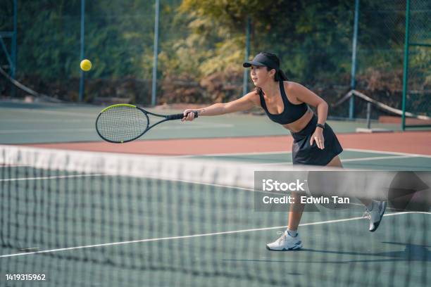 Asian Chinese Female Tennis Player Practising Learning Tennis In Hardcourt During Weekend Morning Stock Photo - Download Image Now