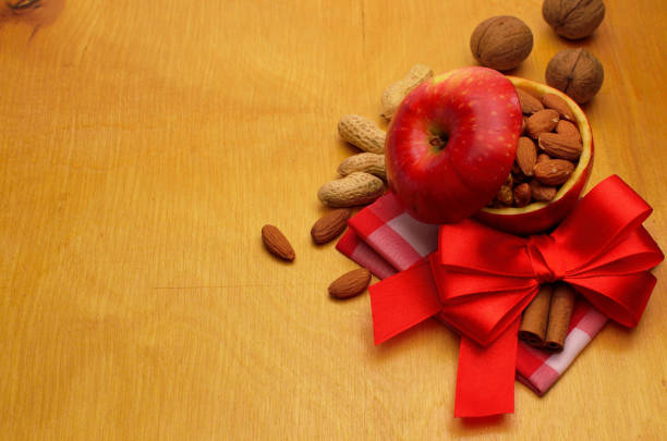 nuts in an apple on a wooden board background