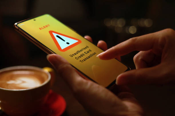 Financial fraud alert message on smartphone stock photo