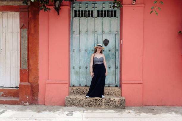 istock Girl in front of a blue door 1419316955
