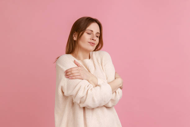 istock Woman hugging herself and smiling, feeling comfortable and fulfilled, narcissistic egoistic person. 1419317741