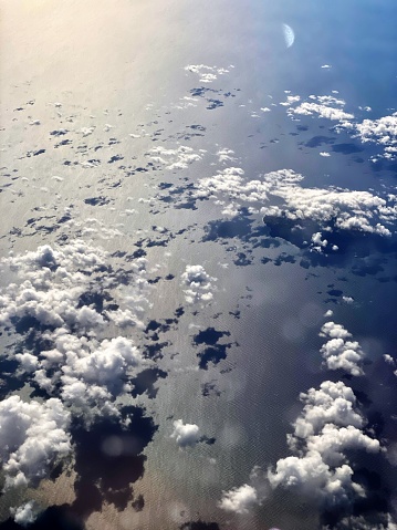 blue sky cumulus clouds image of a calm sea