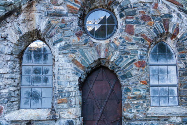 istock Old stone chapel with a door and windows 1419319154