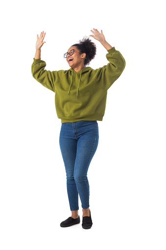 Black woman wearing casual clothes cheering with arms stretched screaming of joy full length portrait isolated over a white background