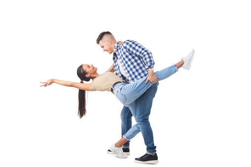 Picture of a young couple dancing isolated over white background