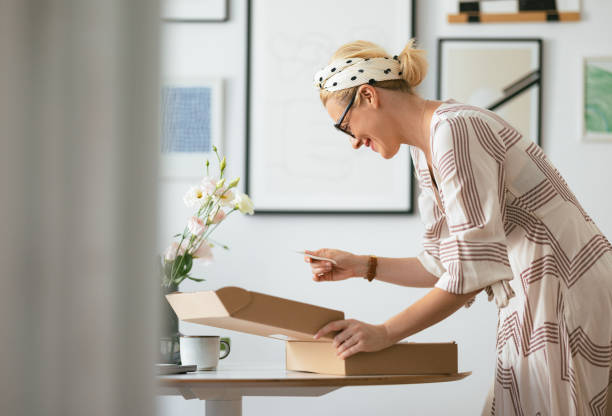 istock Beautiful Woman Happy While Reading a Note She Received With the Carton Box 1419325068