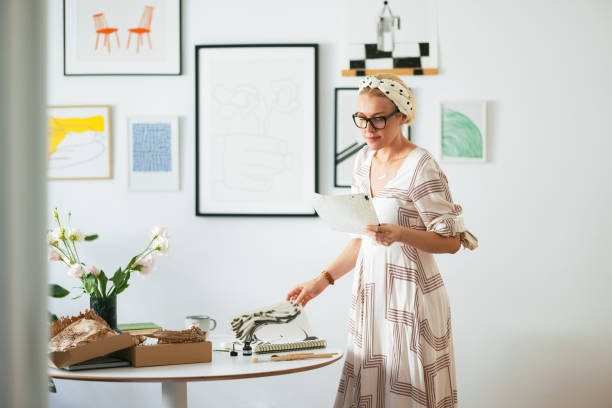 istock Beautiful Female Artist Looking at Her Drawings 1419325810
