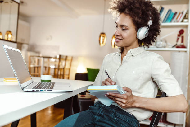 Woman listening to online education training class stock photo