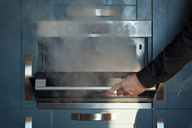 Blue kitchen with a stove with burnt food