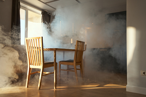 Fogged kitchen with wooden furniture in a sunset light coming through the window