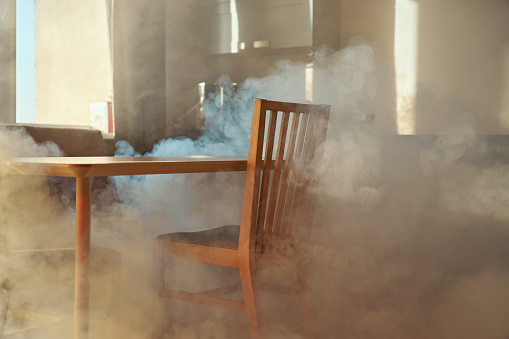 Smoke in a kitchen with wooden furniture. Oven accident at kitchen