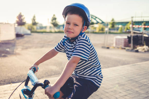 istock Happy kid boy, having fun in park with a bicycle on beautiful sunny day. 1419330510