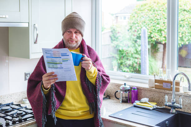 istock Cold and worried man checking bills at home 1419332388