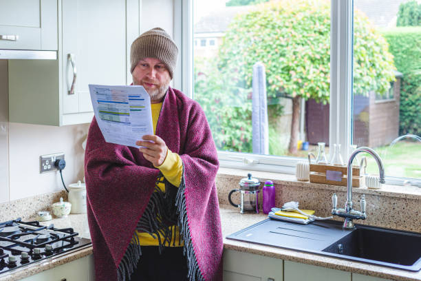 istock Cold and worried man checking bills at home 1419332464