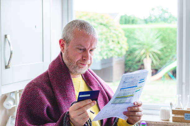 istock Cold and worried man checking bills at home 1419332488