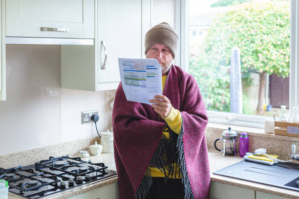 istock Cold and worried man checking bills at home 1419332572