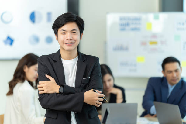istock Business people showing team work while working in board room in office interior. People helping one of their colleague to finish new business plan. Business concept. Team work. 1419335639