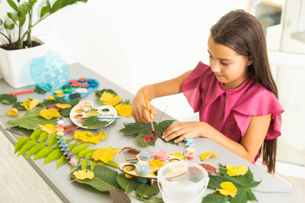 istock Children's picture made from autumn leaves paint 1419336318
