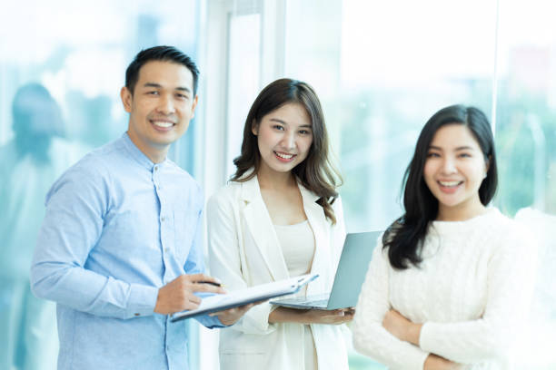 istock Business people showing team work while working in board room in office interior. People helping one of their colleague to finish new business plan. Business concept. Team work. 1419337090