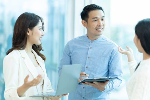 istock Business people showing team work while working in board room in office interior. People helping one of their colleague to finish new business plan. Business concept. Team work. 1419337967