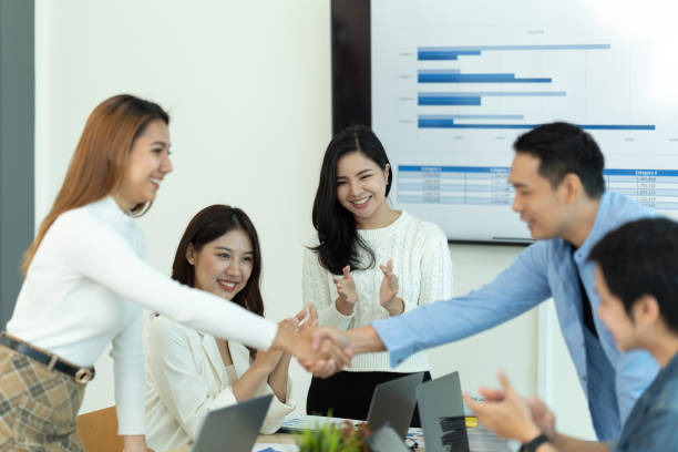 istock Business people showing team work while working in board room in office interior. People helping one of their colleague to finish new business plan. Business concept. Team work. 1419338673