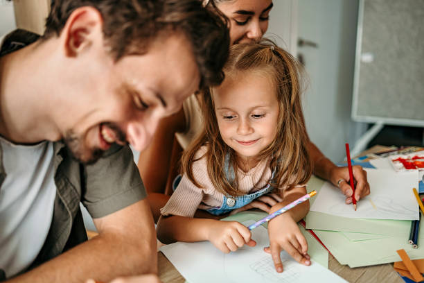 istock Young family having fun and drawing together 1419338742
