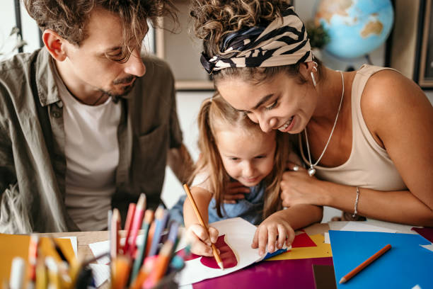 Young family having fun and drawing together