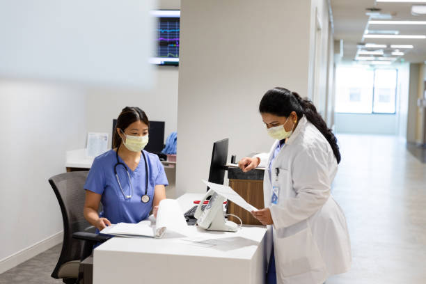 istock Doctor stands at nurse workstation 1419342601