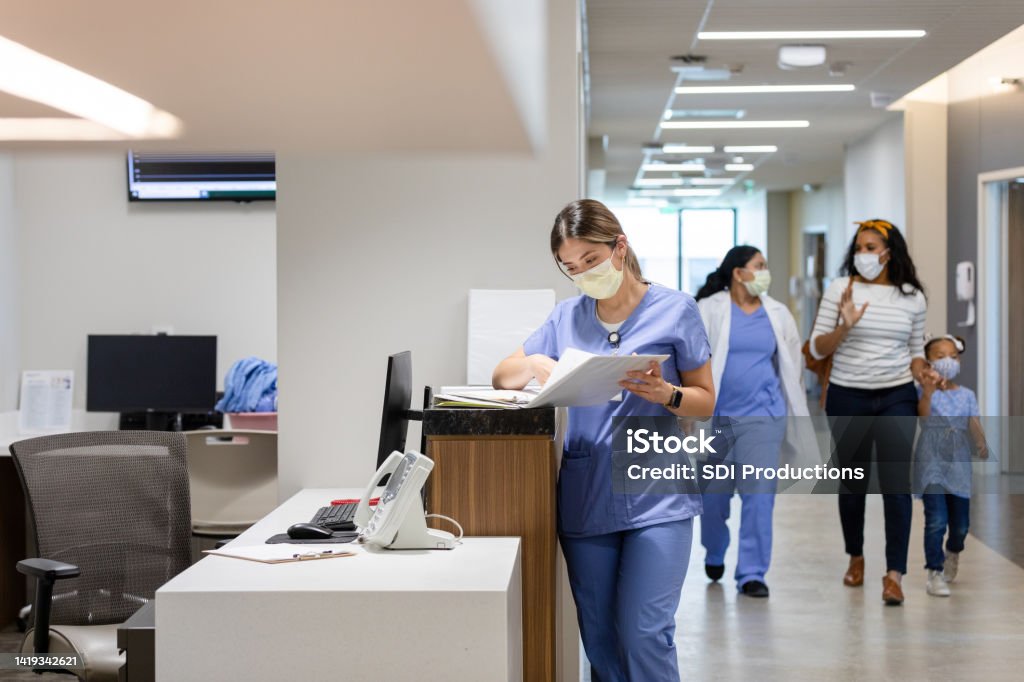 Doctor walks patient to their room The doctor walks the patient to their room as they await surgery. Nurse Stock Photo