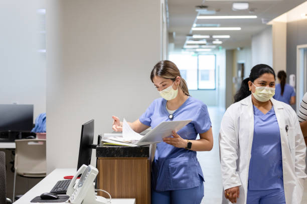 istock Charge nurse stands at the computer 1419342623
