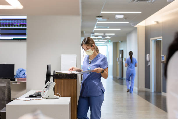 istock Nurse stands at the computer desk 1419342627