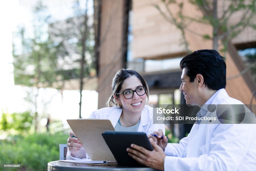 Medical students meet The medical students meet outside and talk about the upcoming lecture they will attend. Mentorship Stock Photo