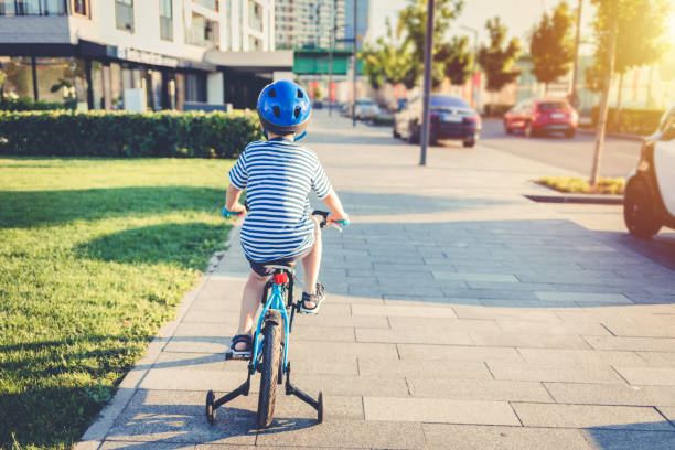 istock Happy kid boy, having fun in park with a bicycle on beautiful sunny day. 1419342713