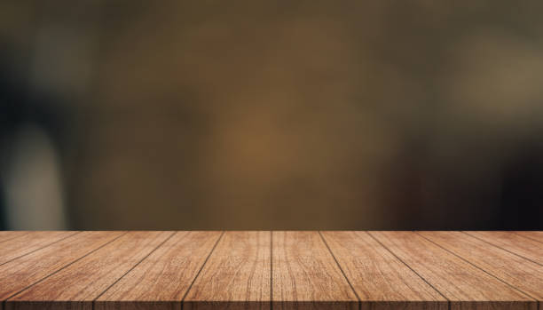 istock Empty wooden table top with lights bokeh on blur restaurant background. 1419343486