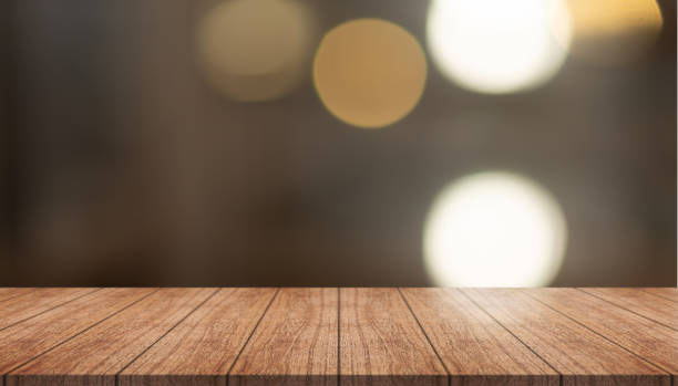istock Empty wooden table top with lights bokeh on blur restaurant background. 1419343541